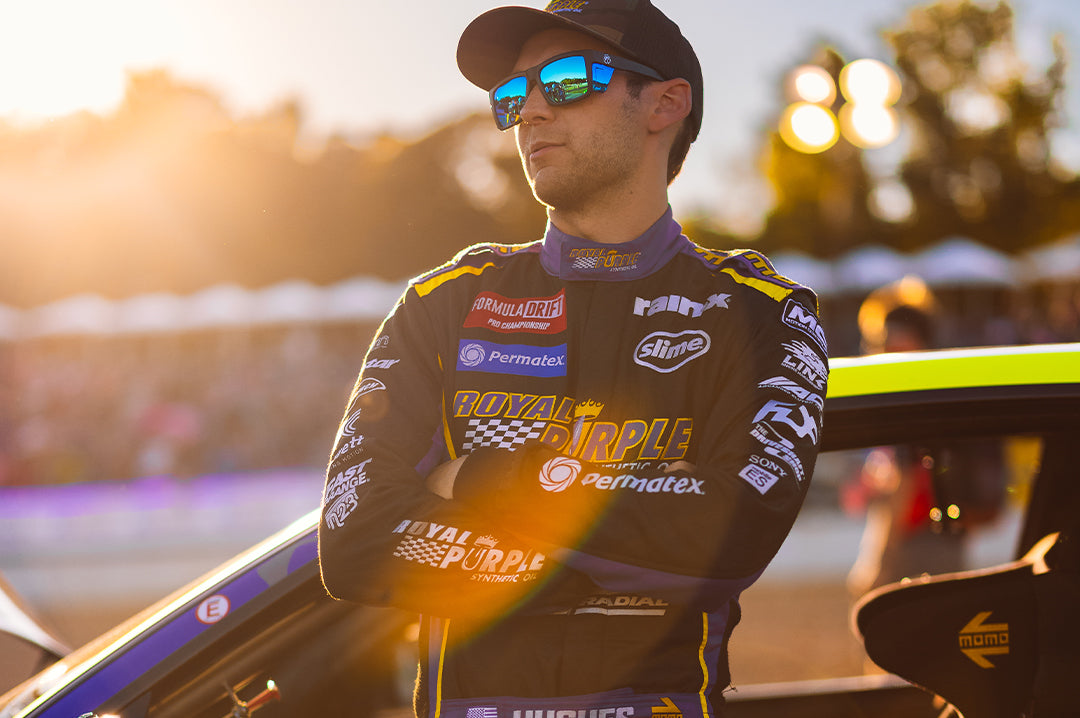 Dylan Hughes wearing the Heat Wave Visual Performance Vise Sunglasses with black frame, galaxy blue lenses and matching colored side shields.