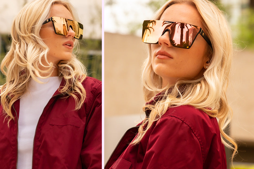 City Girl wearing the Heat Wave Visual Clarity Sunglasses with black frame and rose gold lens.